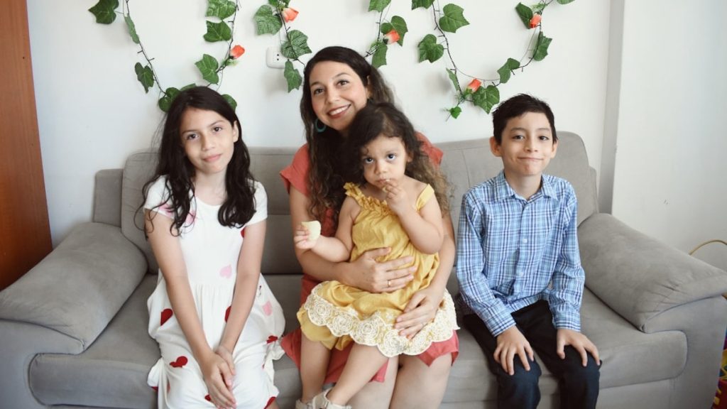 a group of people sitting on a couch posing for the camera